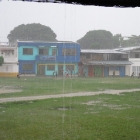 Kids playing fútbol in the Capurganá «square» under a heavy rain